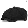 Black vintage retro newsboy cap with a textured fabric and a folded brim.