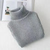 A light gray knit turtleneck sweater for kids displayed on a white surface.