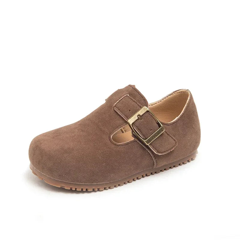 A brown suede moccasin shoe for a child with an easy hook-and-loop closure.