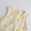A cream-colored baby cotton sleeveless jumpsuit bodysuit set with scattered orange polka dots.