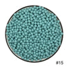 A circular arrangement of small, light blue water beads in a black dish.