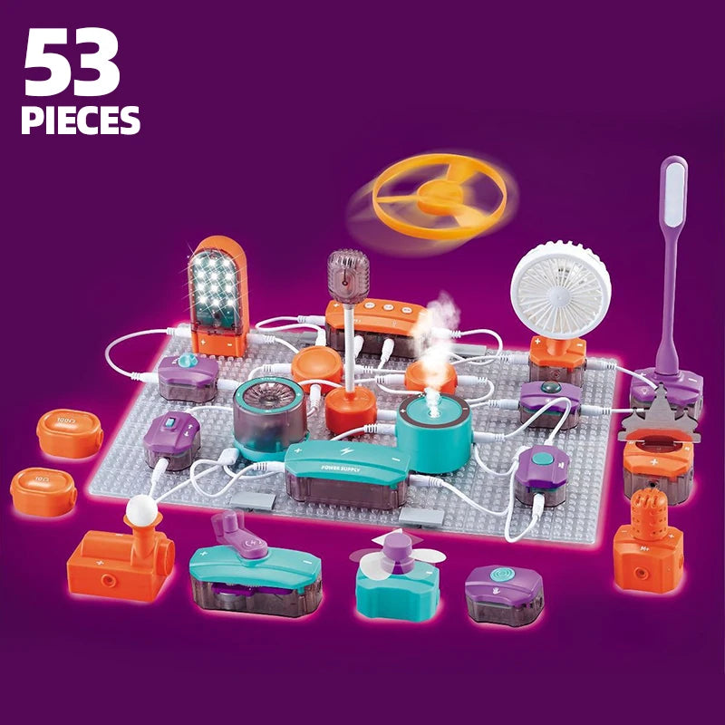 A collection of colorful electronic circuit building blocks and components arranged on a white board with an orange fan above