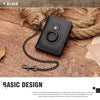 A black Crazy Horse leather smart wallet with a chain attached, resting on a wooden surface.
