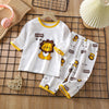 White long-sleeve cotton pajama set for kids featuring a lion print and yellow trim