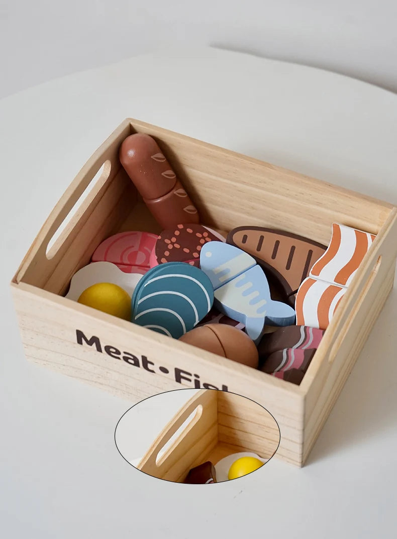 A wooden pretend play food cutting set in a light wood box filled with various shaped and colored food items.