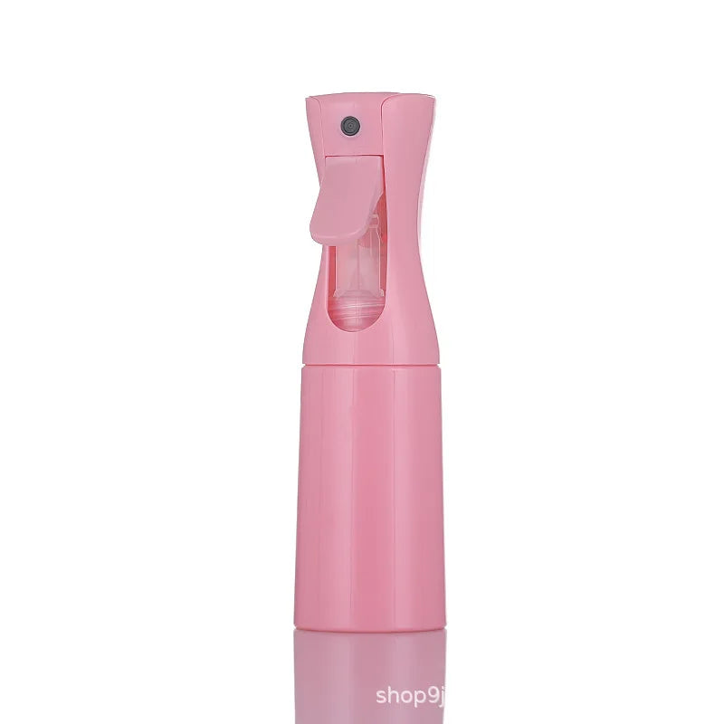 A pink continuous fine mist spray bottle for hair, skin, and plants.