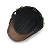 A black knit wool newsboy cap with a brown felt crown and brim.
