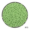 A circular arrangement of small, light green water beads.