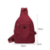 A maroon lightweight Oxford cloth mini backpack shown from the back with a strap detail.