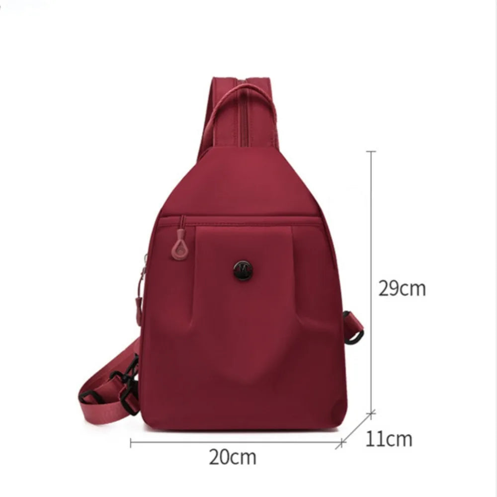 A maroon lightweight Oxford cloth mini backpack shown from the back with a strap detail.