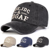 A dark gray baseball cap embroidered with the text IDK, IDC & DGAF