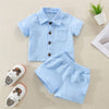 A light blue textured cotton linen shirt and matching shorts set for a toddler.