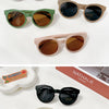 A collection of various sunglasses in black, tortoise, and olive green frames and lenses displayed on a white background.