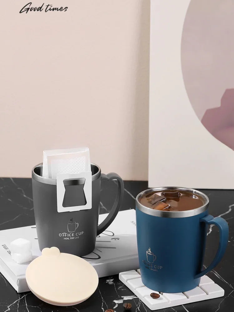 A blue stainless steel insulated travel mug is shown next to a white lid and a light-colored coaster on a dark surface.