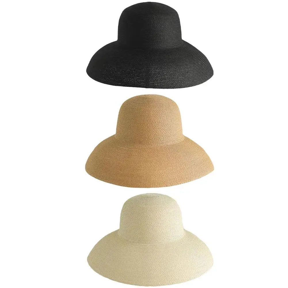 Three wide brim straw sun hats in black, beige, and cream.