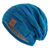 A teal and blue knit beanie with a slouchy fit and a gray accent stripe.