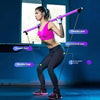 A woman demonstrates a full-body workout using an adjustable Pilates bar and resistance bands for exercise.