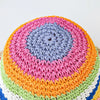 A colorful rainbow striped crochet bucket hat featuring various shades of pink, purple, blue, orange, and green.