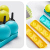 A collection of colorful bounce balls in various shades of yellow and blue arranged on a plastic tray.