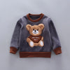 A gray sweatshirt with a brown trim features a embroidered teddy bear design and the text THISISNOT ABCY