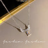 Silver crystal bow angel wings heart pendant necklace displayed on a light background.