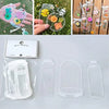 A collection of DIY transparent dried flower bookmarks and decorative items displayed on a white surface.