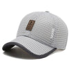 A light gray mesh baseball cap with a dark patch on the front, shown from above.