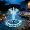 A blue solar floating water fountain with RGB LED lights is operating in a garden pond.