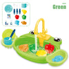 A green kids pretend play kitchen sink set with running water and various colorful food items.
