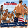 Group of men smiling and enjoying summer memories on a beach with patriotic swim trunks