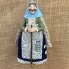 Handcrafted kitchen witch doll with antique charm wearing a green dress and blue hood