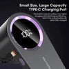 A close-up view of a Mini Hairba rechargeable fabric shaver and lint remover with a digital display showing 100% charge.