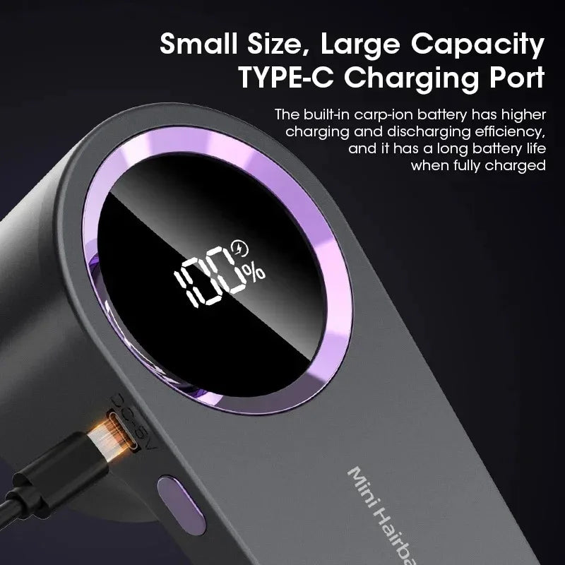 A close-up view of a Mini Hairba rechargeable fabric shaver and lint remover with a digital display showing 100% charge.