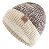 A two-tone knit beanie featuring a brown and gray pattern with a cream faux fur lining.