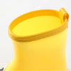 A bright yellow kids' waterproof rain boot with a rolled cuff and smooth surface.