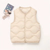 A beige quilted vest for a child, displayed next to a small stuffed animal.