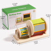 A wooden rolling drum toy with colorful dowels and a green box, designed for toddler exploration.