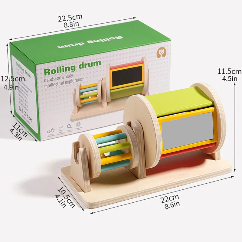 A wooden rolling drum toy with colorful dowels and a green box, designed for toddler exploration.