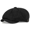 Black vintage retro newsboy cap with a textured fabric and a folded brim.