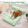 A brown dog lying on a green pet mat with avocado prints, designed for gentle comfort.