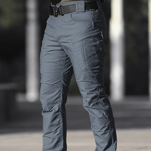 Gray men's tactical cargo pants with multiple pockets shown from the front.