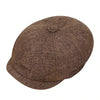 A brown vintage tweed flat cap with a leather label shown from above.