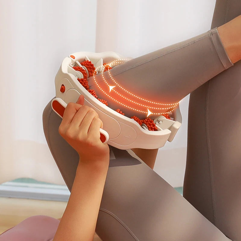 A person is using a full body massage roller with detachable handles on their leg, showing the massage points glowing.
