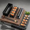Kit de confection de sushi noir avec dix moules et huit formes, incluant une planche en bois et des outils.