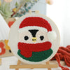 Punch needle embroidery kit featuring a red Santa hat and white snowman face with green accents