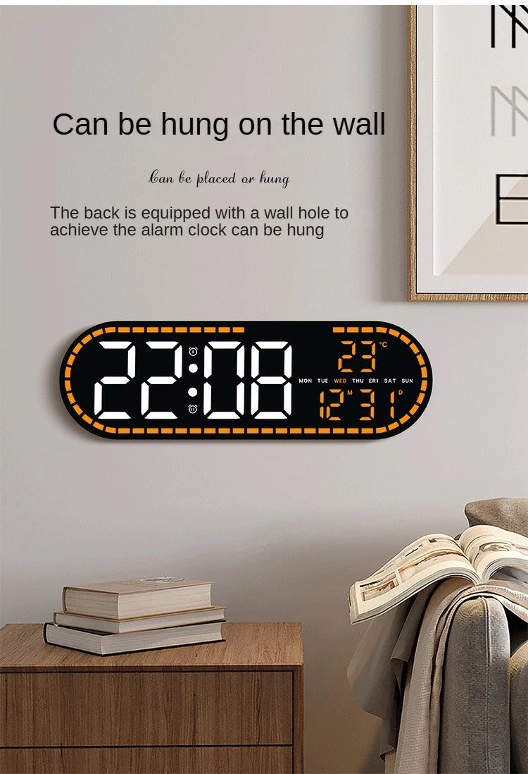 A black digital wall clock displaying the time 22:08, date, and temperature, mounted on a light gray wall.