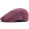 Gorra tipo newsboy de mezcla lavada en malva, estilo boina retro, vista lateral.