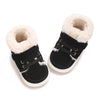 A pair of black baby winter snow boots with light beige faux fur lining and gold hardware.