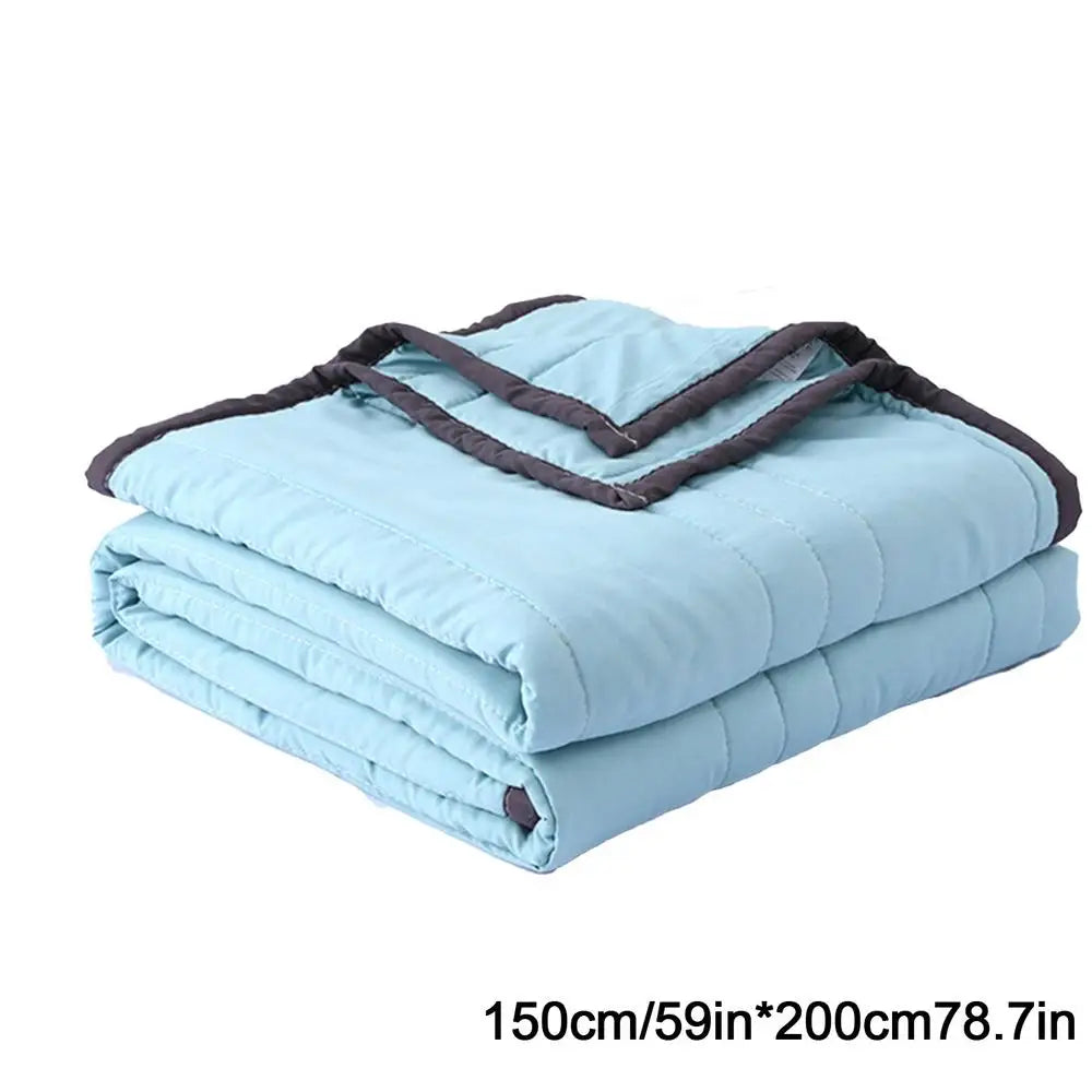 Light blue breathable cooling throw blanket folded and stacked for hot sleepers