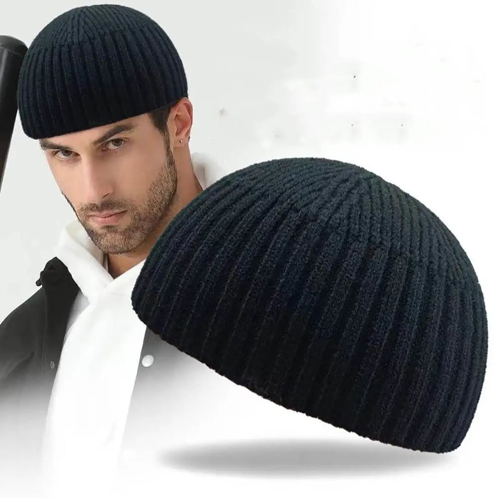 A man wearing a black knitted beanie hat.
